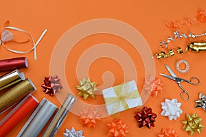 Gift wrapping utensils on orange ground