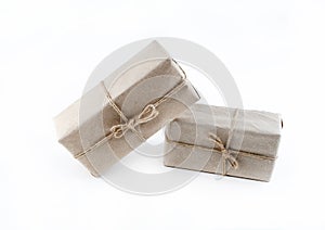 Giftbox couple of surprises in natural craft paper on isolated background, birthday gift