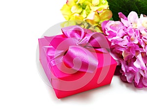 Giftbox pink present on white background with ribbon and beautiful flower