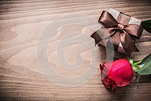 Giftbox red rose on wooden board copy space