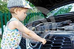 Gifted kid repairing car engine