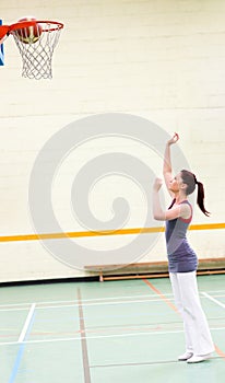 Gifted woman practicing basketball