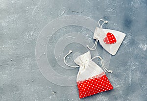 Gifting theme image with a checkered fabric pouch and a decorative red heart