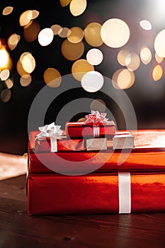 Gifts on the background of a Christmas tree with a bokeh.