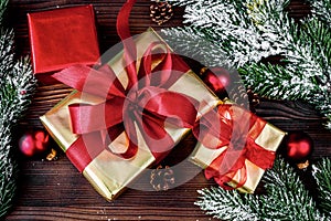 Gifts boxes with fir branches on wooden background top view