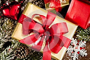 Gifts boxes with fir branches on wooden background top view