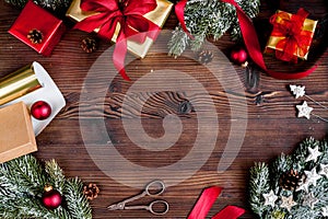 Gifts boxes with fir branches on wooden background top view