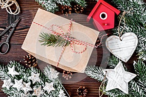 Gifts boxes with fir branches on wooden background top view