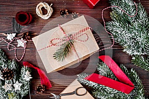 Gifts boxes with fir branches on wooden background top view