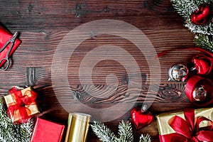 Gifts boxes with fir branches on wooden background top view