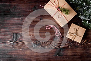 Gifts boxes with fir branches on wooden background top view