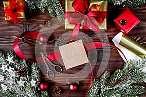 Gifts boxes with fir branches on wooden background top view