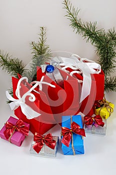 Gifts in boxes and red bags on a white background