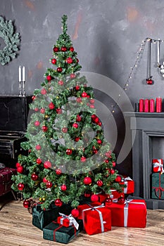 Gifts and Christmas tree. Festive Christmas interior. A beautiful living room decorated for Christmas with gifts