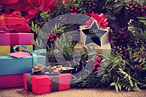gifts, christmas wreath and text merry christmas in a star-shaped signboard