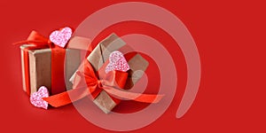 Gifts  and decor hearts  on red background. Minimalist concept for Valentines day Mothers day, Women day or wedding.