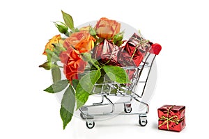 Gifts and flowers in the shopping cart. Buyer`s basket. Full shopping cart. White isolated background. The concept of gifts and