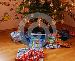 Gifts lie under christmas tree