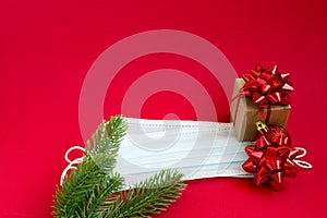 Gifts and medical mask on a red background. Christmas. Decorative composition on a red background. Coronavirus Christmas. Observan photo