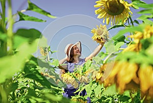 Gifts of nature. happy childhood. kid wear straw summer hat. child in field of yellow flowers. teen girl in sunflower