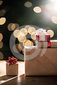 Gifts on the background of a Christmas tree with a bokeh.