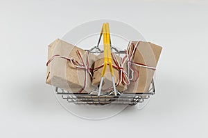 Gifts in a small shopping basket on a white background, concept, copy space