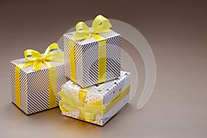 Gifts in three boxes wrapped in decorative paper with pictures. A surprise for any occasion and event.