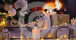 Gifts under the Christmas tree in front of fireplace