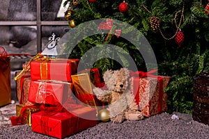 Gifts under the Christmas tree, toy bear and boxes, the concept of a cozy home new year.Bear waiting Santa ,Christmas