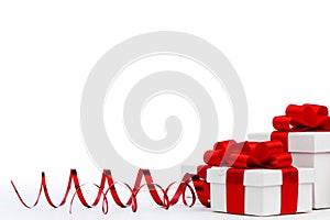 Gifts in white boxes with red ribbons