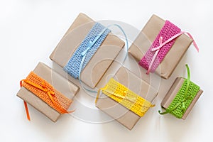 Gifts wrapped in kraft paper and tape knitted from yarn.