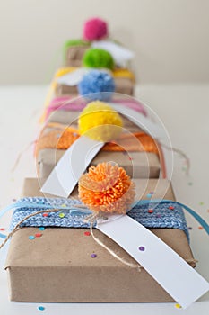 Gifts wrapped in kraft paper and tied with ribbons knitted.