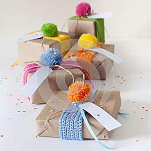 Gifts wrapped in kraft paper and tied with ribbons knitted.