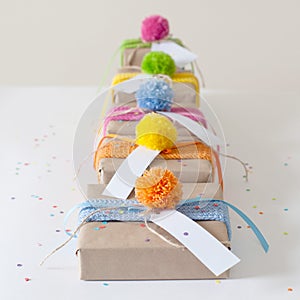 Gifts wrapped in kraft paper and tied with ribbons knitted.