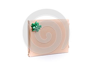 Giftwrapped present with a decorative green bow