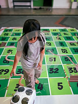 Gigantic dice on rope game or dam tali in Malay language