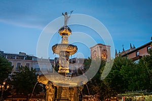 Gigantones Fountain at Plaza de Bib-Rambla Square at night with Cathedral Tower - Granada, Andalusia, Spain