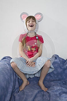 giggle girl wearing cap with mouse`s ears photo