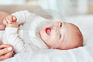 Giggles, cuddles and snuggles. an adorable baby boy bonding with his mother at home.