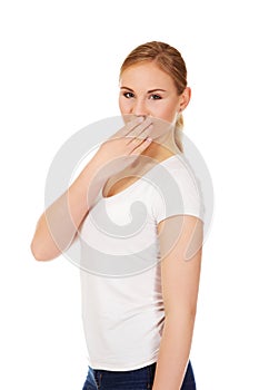 Giggles young woman covering her mouth with hand