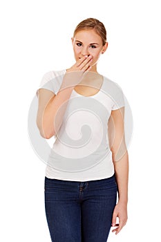 Giggles young woman covering her mouth with hand