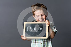 Giggling boy with slate against French 'poux' or head lice