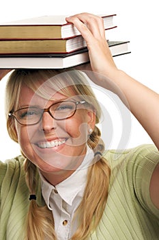 Giggling Woman Under Stack of Books on Head