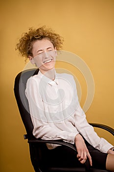 Gigling office worker sitting on the chair