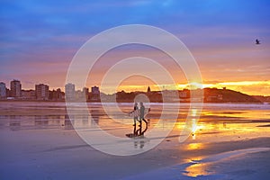 Gijon sunset San Lorenzo beach surfers in Asturias