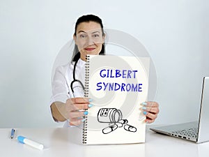 GILBERT SYNDROME text in list. Hematologist looking for something at laptop