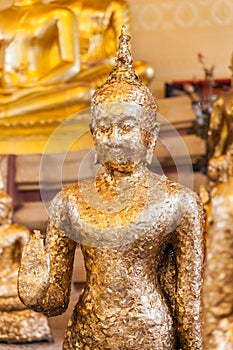 Gild ancient buddha statue in a Thai temple