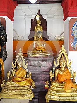 Gilded Buddha images in `earth-touching` and meditative pose, Viharn Tap Kaset gallery, Wat Mahathat, Nakhon Si Thammarat