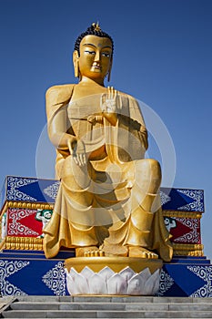 gilded buddha statue on blue sky background