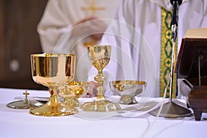 gilded chalices and bowls during a service on the altar